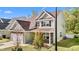 Inviting two-story home with an attached garage and well-maintained lawn, showcasing its pleasant curb appeal at 69 Florence Dr, Clayton, NC 27527