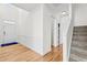 Bright foyer featuring hardwood floors, staircase, and attractive wall trim detail at 69 Florence Dr, Clayton, NC 27527