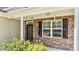 Home exterior featuring a front door with stone veneer and decorative shutters at 69 Florence Dr, Clayton, NC 27527