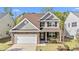 Charming two-story home featuring a stone-accented facade, attached garage, and beautifully landscaped front yard at 69 Florence Dr, Clayton, NC 27527