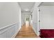 Bright hallway with hardwood floors and elegant wainscoting, offering a glimpse into the home's layout at 69 Florence Dr, Clayton, NC 27527
