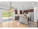 Open concept kitchen with stainless steel appliances, center island, and sliding glass doors to the backyard at 69 Florence Dr, Clayton, NC 27527