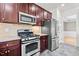 Modern kitchen featuring stainless steel appliances, tile backsplash, and ample cabinet space at 69 Florence Dr, Clayton, NC 27527