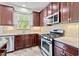 Well-equipped kitchen with granite countertops, stainless steel appliances, and abundant storage space at 69 Florence Dr, Clayton, NC 27527