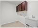 Laundry room with tile flooring, upper cabinets, and utility sink at 69 Florence Dr, Clayton, NC 27527