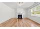 Bright living room with a fireplace, ceiling fan, and large window allowing natural light at 69 Florence Dr, Clayton, NC 27527