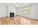Spacious living room with a fireplace, hardwood floors, and a window for natural light at 69 Florence Dr, Clayton, NC 27527
