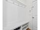 Well-organized mudroom entrance with a built-in bench, shelving, and coat hooks by the door at 69 Florence Dr, Clayton, NC 27527