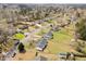 Aerial view of neighborhood street highlighting the mature trees and well kept lawns at 711 Wheat Mill Rd, Durham, NC 27704