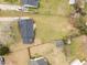 Aerial view of property with shed and partially fenced large lot with mature trees at 711 Wheat Mill Rd, Durham, NC 27704