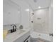 Modern bathroom features tiled walk-in shower, white vanity with black hardware, and updated mirror at 711 Wheat Mill Rd, Durham, NC 27704