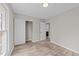 This bright bedroom features light hardwood floors, a window, and a closet at 711 Wheat Mill Rd, Durham, NC 27704