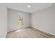 Bright bedroom features light hardwood floors, a window, and neutral-colored walls at 711 Wheat Mill Rd, Durham, NC 27704