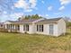 Side view of a one-story house featuring white siding, black shutters, and a green lawn at 711 Wheat Mill Rd, Durham, NC 27704