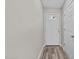 Bright entryway with wood-look flooring, leading to a white door and storage closet at 711 Wheat Mill Rd, Durham, NC 27704
