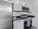 Updated kitchen featuring stainless steel appliances, black granite counters, and white subway tile at 711 Wheat Mill Rd, Durham, NC 27704