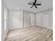 Spacious living room with stylish flooring, white brick accent wall, and recessed lighting at 711 Wheat Mill Rd, Durham, NC 27704