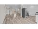 Open-concept living space with stylish floors, leading to the front door and kitchen with modern appliances at 711 Wheat Mill Rd, Durham, NC 27704