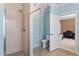 Contemporary bathroom with glass-enclosed shower, toilet, and view into the bedroom at 714 Waterford Lake Dr, Cary, NC 27519