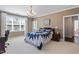 Spacious bedroom with hardwood floors, a cozy blue quilt, and a charming chandelier at 714 Waterford Lake Dr, Cary, NC 27519