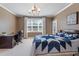 Bedroom featuring desk, a window with a backyard view, and tan walls with white trim at 714 Waterford Lake Dr, Cary, NC 27519