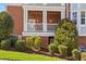 Brick apartment building, manicured lawn with lush green shrubs and a charming balcony at 714 Waterford Lake Dr, Cary, NC 27519