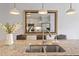 Kitchen island with double sink, stainless steel faucet, granite countertops, and pendant lights at 714 Waterford Lake Dr, Cary, NC 27519