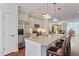 Open concept kitchen with island seating, granite countertops, stainless appliances, and hardwood floors at 714 Waterford Lake Dr, Cary, NC 27519