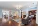 Open-concept living room with fireplace, hardwood floors, comfortable seating and decorative rug at 714 Waterford Lake Dr, Cary, NC 27519