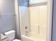 Bright bathroom featuring a white shower-tub combo with chrome fixtures and a gray wall at 8 Elaine Cir, Durham, NC 27703