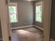 Bright bedroom with hardwood floors and large windows offering ample natural light at 8 Elaine Cir, Durham, NC 27703