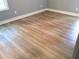 Bedroom floor features light colored wood style flooring with white trim and baseboards at 8 Elaine Cir, Durham, NC 27703