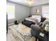 Cozy bedroom with neutral walls, a large window, area rug, and comfortable seating, creating a relaxing retreat at 8 Elaine Cir, Durham, NC 27703