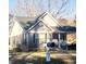 Charming home featuring gray siding, a cozy porch, and well-maintained landscaping at 8 Elaine Cir, Durham, NC 27703