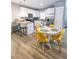 Bright kitchen and dining area featuring white cabinets, granite countertops, and stainless steel appliances in an open layout at 8 Elaine Cir, Durham, NC 27703