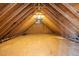Unfinished attic space with exposed rafters, wood sheathing, and a gable vent bringing in natural light at 8116 Windsor Ridge Dr, Raleigh, NC 27615