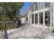 The back deck features a grill and adjoins a home with a wall of windows providing ample natural light at 8116 Windsor Ridge Dr, Raleigh, NC 27615