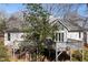 The back of the house shows a spacious deck, large windows and a gray roof surrounded by trees at 8116 Windsor Ridge Dr, Raleigh, NC 27615