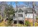 The back of the house shows a deck with a grill, large windows and a gray roof surrounded by trees at 8116 Windsor Ridge Dr, Raleigh, NC 27615