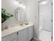 Bright bathroom with marble countertops, updated sink, cabinet space, and a view into the shower and toilet area at 8116 Windsor Ridge Dr, Raleigh, NC 27615