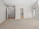 Bright bedroom with carpet and large closets with light wood flooring at 8116 Windsor Ridge Dr, Raleigh, NC 27615