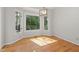 Bright dining area with hardwood floors and expansive windows looking out onto lush greenery at 8116 Windsor Ridge Dr, Raleigh, NC 27615