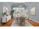 The dining room boasts hardwood floors, coffered ceilings, a modern light fixture and French doors leading to the living room at 8116 Windsor Ridge Dr, Raleigh, NC 27615
