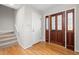 Inviting entryway with hardwood floors and a wooden front door with glass details at 8116 Windsor Ridge Dr, Raleigh, NC 27615