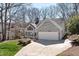 Charming home with stone accents, bright lawn, and an attached two car garage at 8116 Windsor Ridge Dr, Raleigh, NC 27615