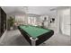 Large game room featuring a pool table and bar area for entertaining at 8116 Windsor Ridge Dr, Raleigh, NC 27615