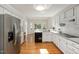 Spacious white kitchen with stainless steel appliances and a large bay window offering plenty of natural light at 8116 Windsor Ridge Dr, Raleigh, NC 27615