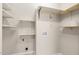 Functional laundry room with open shelving and utility connections at 8116 Windsor Ridge Dr, Raleigh, NC 27615