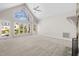 Bright living room boasts vaulted ceiling, floor to ceiling windows, and a cozy fireplace, perfect for gatherings at 8116 Windsor Ridge Dr, Raleigh, NC 27615