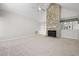 Bright living room features a stone fireplace, built in shelves and a large window allowing for plenty of natural light at 8116 Windsor Ridge Dr, Raleigh, NC 27615